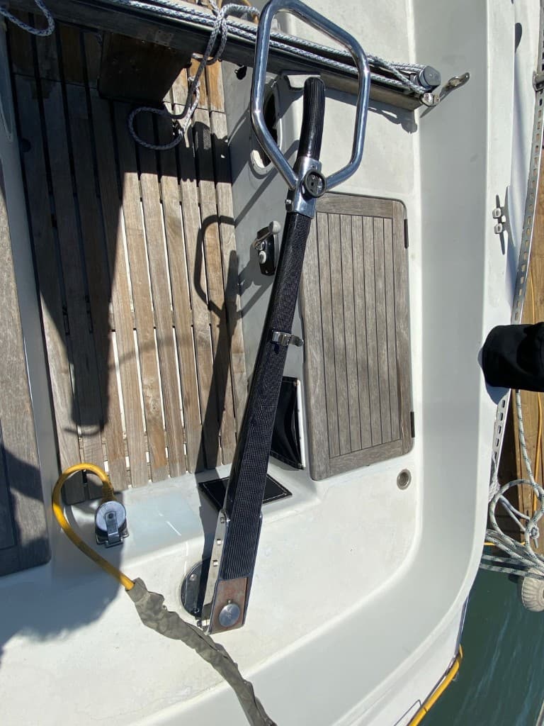 Custom carbon tiller and stainless hardware in a teak cockpit